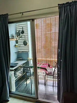 a view of a kitchen from a sliding glass door at Green home in the big City in Bangkok