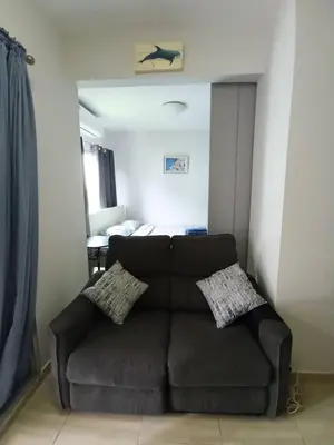 a living room with a couch and a bed at Green home in the big City in Bangkok