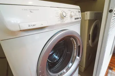 a white washer and dryer in a room at Chez Moi Bangkok Private Executive Residence Sukhumvit 26 in Khlong Toei