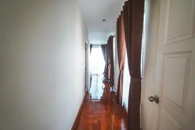 an empty hallway with a door and a window at Chez Moi Bangkok Private Executive Residence Sukhumvit 26 in Khlong Toei