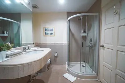 a bathroom with a sink and a shower at Chez Moi Bangkok Private Executive Residence Sukhumvit 26 in Khlong Toei