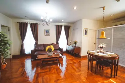 a living room with a couch and a table at Chez Moi Bangkok Private Executive Residence Sukhumvit 26 in Khlong Toei