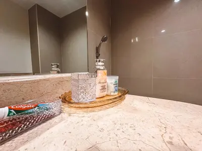 a bathroom counter with a sink and a mirror at Chez Moi Bangkok Private Executive Residence Sukhumvit 26 in Khlong Toei