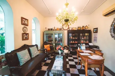 a living room with a couch and a table at Chez Moi Bangkok Private Executive Residence Sukhumvit 26 in Khlong Toei