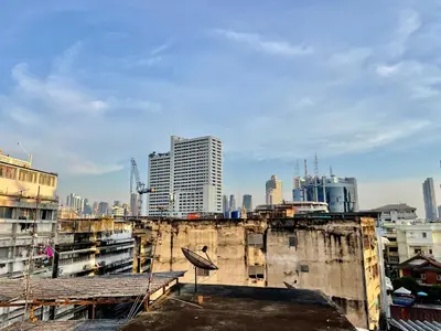 a view of a city from the roof of a building at Baan KhaoSoi - Private room in a rooftop hostel 3rd floor in Khlong San