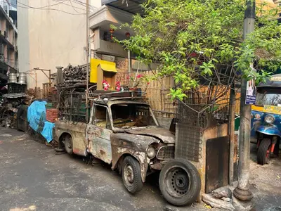 an old truck parked on the side of a street at Baan KhaoSoi - Private room in a rooftop hostel 3rd floor in Khlong San