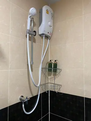 a shower in a bathroom with two bottles on the wall at ศิวพฤกษ์ เพลส in Nonthaburi