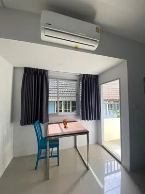 a dining room with a table and a blue chair at ศิวพฤกษ์ เพลส in Nonthaburi