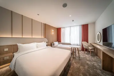 a hotel room with a large bed and a desk at Sotetsu Grand Fresa Bangkok in Bangkok