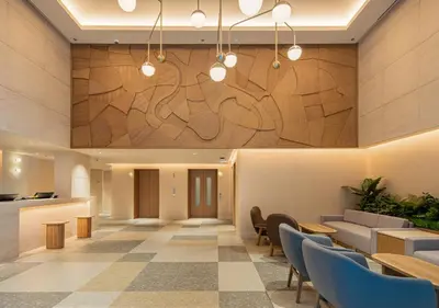 a lobby of a hotel with tables and chairs at Sotetsu Grand Fresa Bangkok in Bangkok
