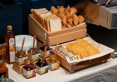 a table with various types of bread and pastries at Sotetsu Grand Fresa Bangkok in Bangkok