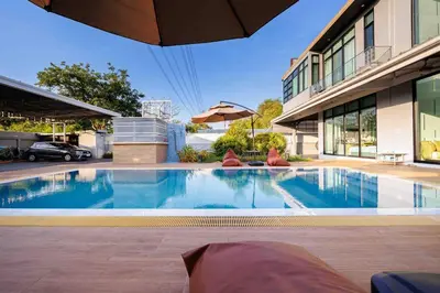 a large swimming pool in front of a building at \u66fc\u8c37\u5e02\u533a700\u5e73\u4e94\u623f\u72ec\u680b\u6cf3\u6c60\u522b\u5885 in Bangkok