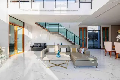 a living room with a couch and a staircase at \u66fc\u8c37\u5e02\u533a700\u5e73\u4e94\u623f\u72ec\u680b\u6cf3\u6c60\u522b\u5885 in Bangkok