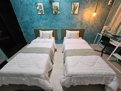 three beds are lined up in a room at Hommie by De-A-Ga in Ban Bang Talat