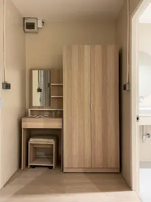 a bathroom with a wooden cabinet and a sink at Rema residence China town Main Road in Bangkok