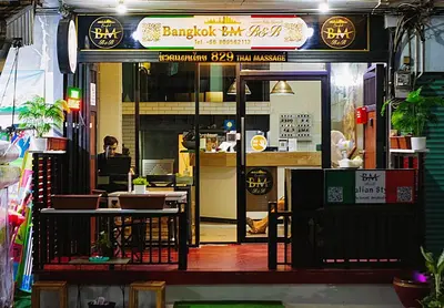 a restaurant with a person sitting at a table at 829 Backpack Bangkok BM B&B in Bangkok
