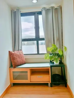 a window seat with two plants in a room at 829 Backpack Bangkok BM B&B in Bangkok