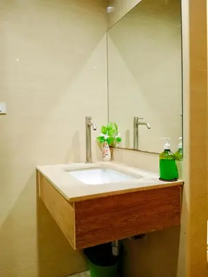 a bathroom with a sink and a mirror at 829 Backpack Bangkok BM B&B in Bangkok