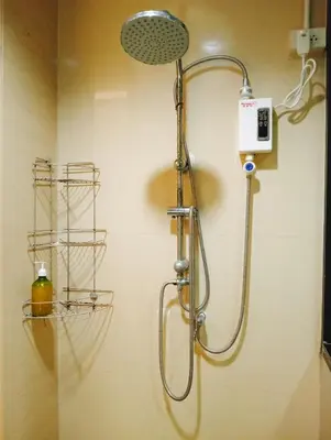 a shower with a shower head in a bathroom at Travel Bangkok BM B&B in Bangkok