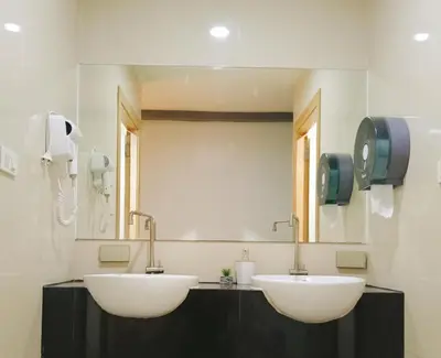 a bathroom with two sinks and a mirror at Travel Bangkok BM B&B in Bangkok