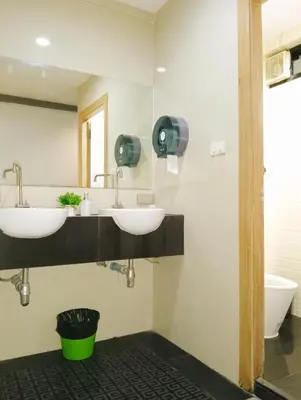 a bathroom with two sinks and a toilet at Travel Bangkok BM B&B in Bangkok