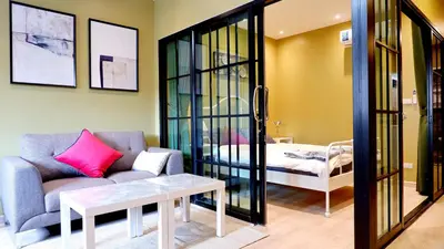 a living room with a couch and a table at BEB Silom Condolette in Bangkok