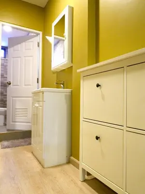 a bathroom with a sink and a white cabinet at BEB Silom Condolette in Bangkok