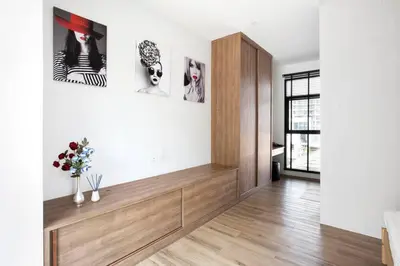 a living room with white walls and a wooden floor at Bangkok Luxury Pool Villa Thonglor in Bangkok