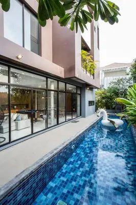 a swimming pool with a swan in the middle of a building at Bangkok Luxury Pool Villa Thonglor in Bangkok