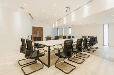 a conference room with a white table and black chairs at Thomson Hotel Huamark in Bangkok