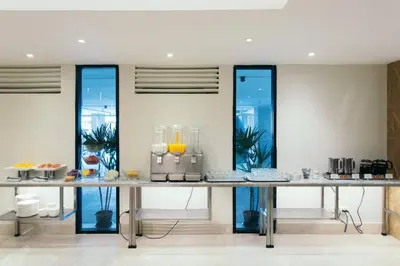 a table with some food on it in a room at Thomson Hotel Huamark in Bangkok