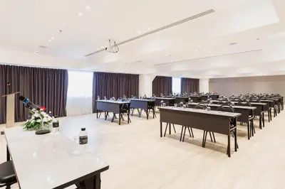 a large banquet hall with tables and chairs at Thomson Hotel Huamark in Bangkok