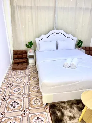 a bedroom with a bed with two towels on it at Guesthouse Station in Bangkok