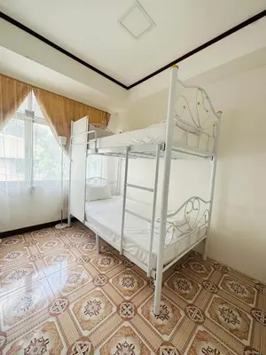 a bedroom with two bunk beds in a room at Guesthouse Station in Bangkok