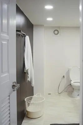 a white bathroom with a toilet and a shower at Hidden Gems in China town, 2BR in Bangkok