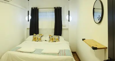 two beds in a small room with a mirror at Hidden Gems in China town, 2BR in Bangkok