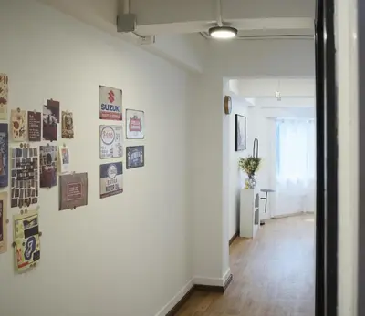 a hallway with a white wall with pictures on it at Hidden Gems in China town, 2BR in Bangkok