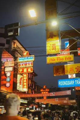 a busy city street at night with neon signs at Hidden Gems in China town, 2BR in Bangkok