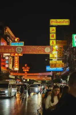 a busy city street at night with neon signs at Hidden Gems in China town, 2BR in Bangkok