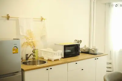 a kitchen counter with a microwave and a sink at 3BR in China Town, Rare to find 2 mins from MRT train in Bangkok