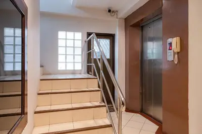 a staircase in a hallway with a door and a window at 23 AVA at Saladaeng in Bangkok