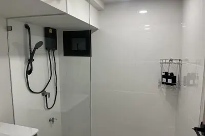 a shower in a bathroom with a glass door at 23 AVA at Saladaeng in Bangkok