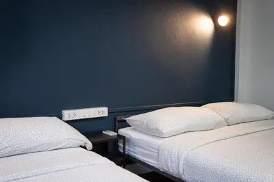 two beds sitting next to each other in a room at A4 Cosy Twin large beds - Silom in Bangkok