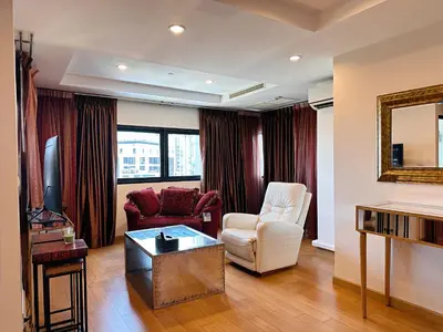 a living room with two chairs and a table at Residence on Sathorn CBD in Bangkok