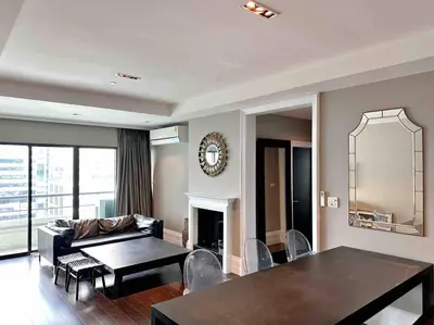 a living room with a table and a couch at Residence on Sathorn CBD in Bangkok