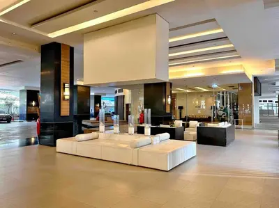 a living room with a white couch in a building at Residence on Sathorn CBD in Bangkok