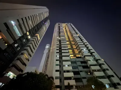 a tall building at night with its lights on at Residence on Sathorn CBD in Bangkok