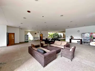 a large living room with couches and a table at Residence on Sathorn CBD in Bangkok