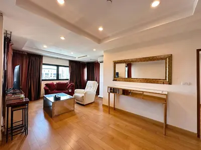 a living room with a desk and a mirror at Residence on Sathorn CBD in Bangkok