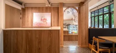 a kitchen with wooden walls and a table and chairs at ZEN MASTER HOTEL in Bangkok